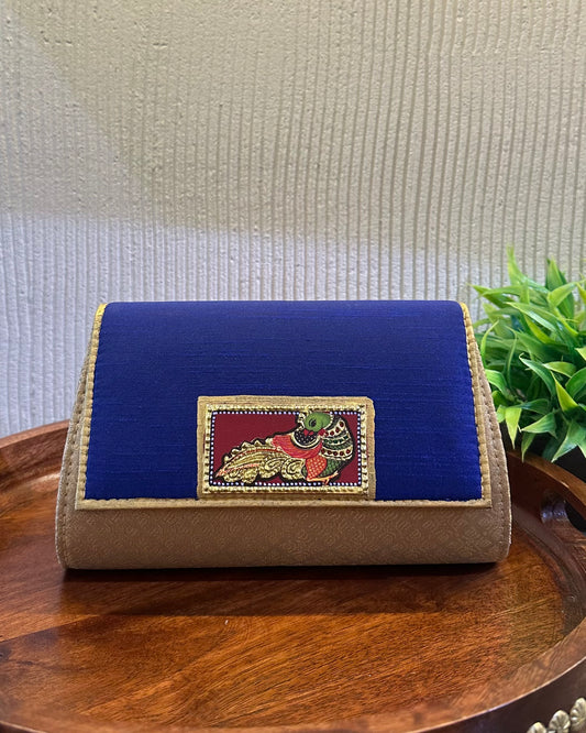 The Tanjore Art clutch-royal blue