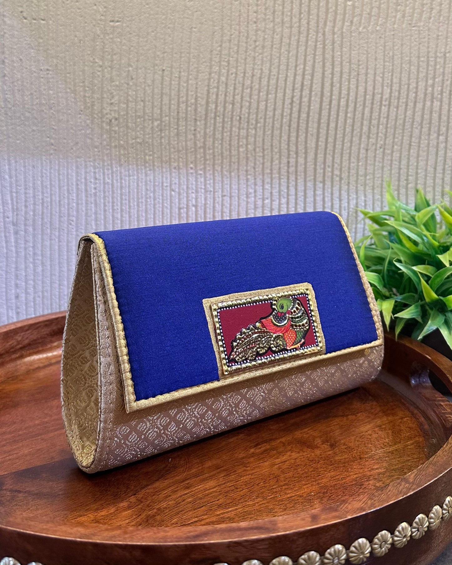 The Tanjore Art clutch-royal blue